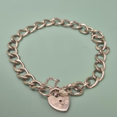 Lot 62 - A 9ct hallmarked gold curb link charm bracelet...