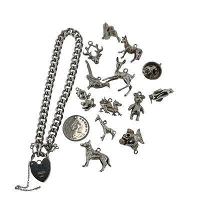 Lot 64 - A hallmarked silver curb chain charm bracelet...