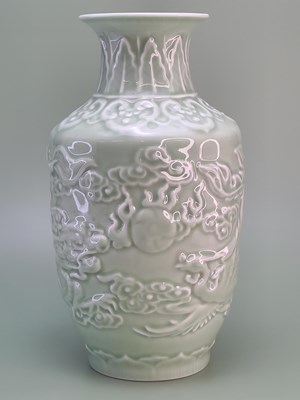 Lot 1845 - A Chinese celadon vase moulded in relief with...