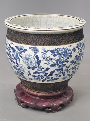 Lot 1853 - A Chinese planter and wood stand, the rounded...