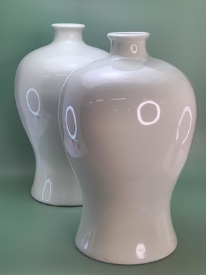 Lot 1858 - A pair of Chinese pale celadon meiping vases....