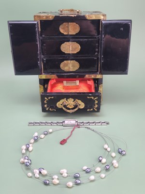 Lot 154 - An Oriental black lacquer table cabinet...