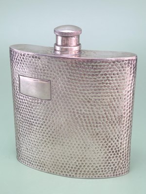 Lot 130 - A hallmarked silver pocket flask with hammered...