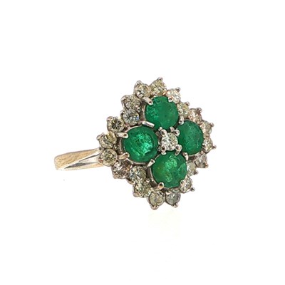 Lot 125 - An emerald and diamond cluster ring, set with...
