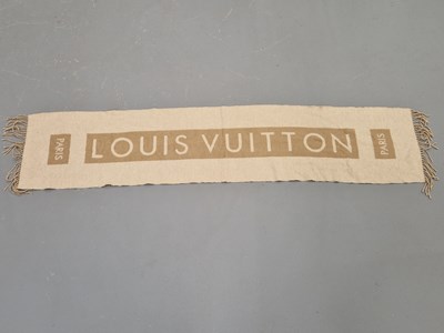 Lot 144 - A Louis Vuitton cashmere scarf in beige and...