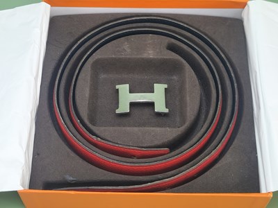 Lot 145 - A Hermes reversible leather belt in black and...