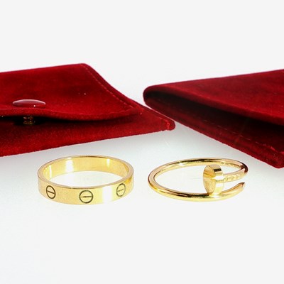 Lot 150 - Two Cartier 18ct gold rings, comprising a...