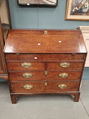Lot 256 - A Georgian oak bureau, the fitted and welled...