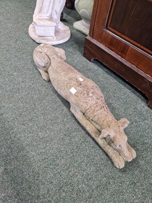 Lot 470a - A cast stone sight hound in a prone position