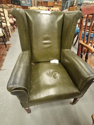 Lot 299 - An Edwardian wing armchair upholstered in...