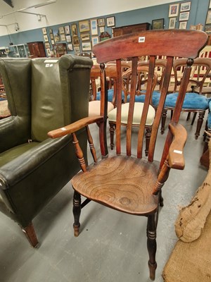 Lot 300 - A 19th century elm seat slat back elbow chair...