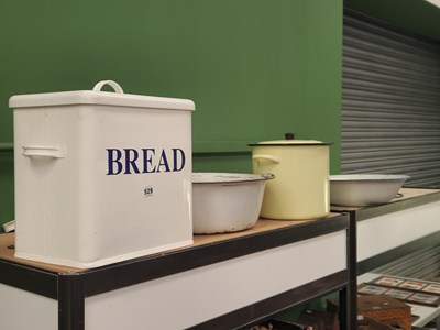 Lot 529 - An enamel 'Bread' bin, two enamel bowls, and a...
