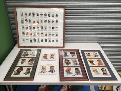 Lot 538 - Military helmets and caps illustrated in a...