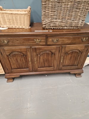 Lot 327 - A 20th century oak sideboard of two drawers...