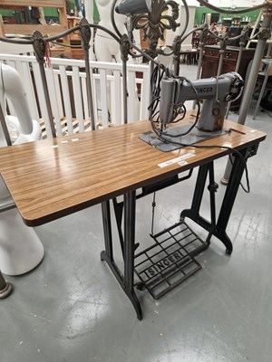Lot 337 - A commercial Singer sewing machine on a cast...