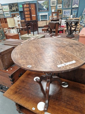 Lot 381 - A Georgian oak tripod tilt top table on a...