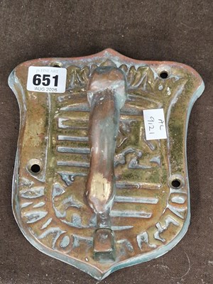 Lot 651 - A bronze door knocker with an arm hammering on...