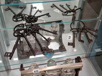 Lot 674 - Two rings of five iron keys