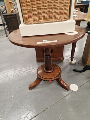 Lot 407 - An antique mahogany tripod table with a turned...