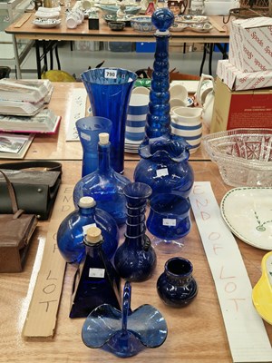 Lot 790 - A collection of blue glass bottles, vases, and...