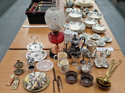Lot 800 - An oil lamp with a cranberry glass receiver,...