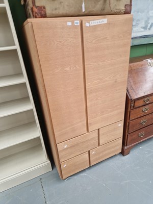 Lot 442 - A modern oak wardrobe the twin hanging...