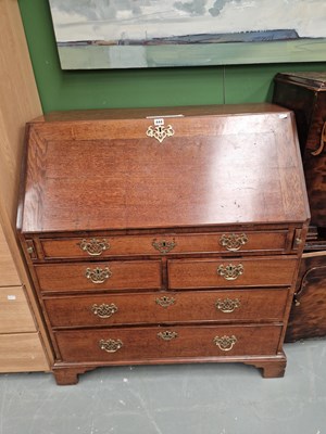 Lot 444 - A 19th century oak bureau, the fitted interior...