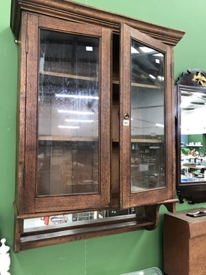 Lot 460 - An antique oak two door glazed wall cabinet...