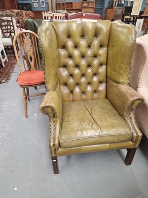 Lot 216 - A vintage Georgian style button back wing back...