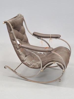 Lot 1 - A Victorian wrought iron rocking chair...