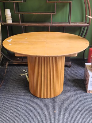 Lot 2 - A contemporary blond oak extending table...