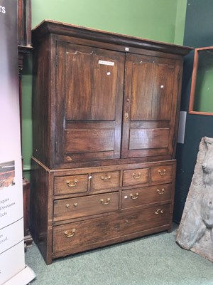 Lot 5 - An 18th century oak linen press, the doors to...