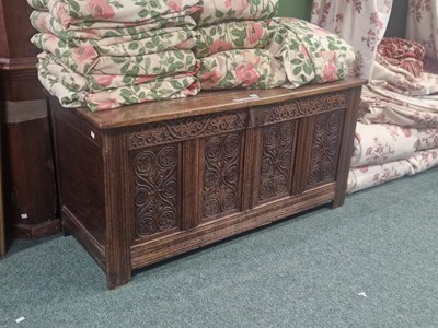 Lot 15 - An 18th century oak coffer, the four panels to...