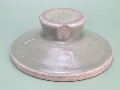 Lot 1872 - A Chinese celadon smoothing pad with four...