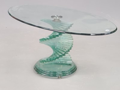 Lot 46 - An oval glass coffee table supprted on a...