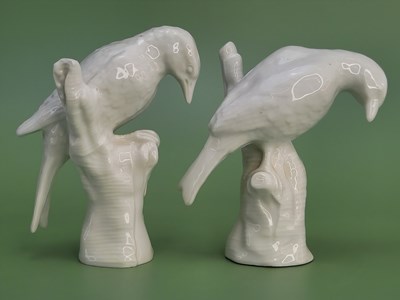 Lot 1883 - A pair of Berlin white glazed birds perched on...