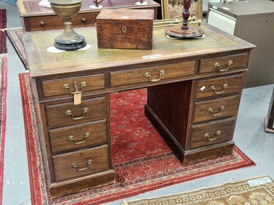 Lot 58 - A mahogany pedestal desk, the leather inset...